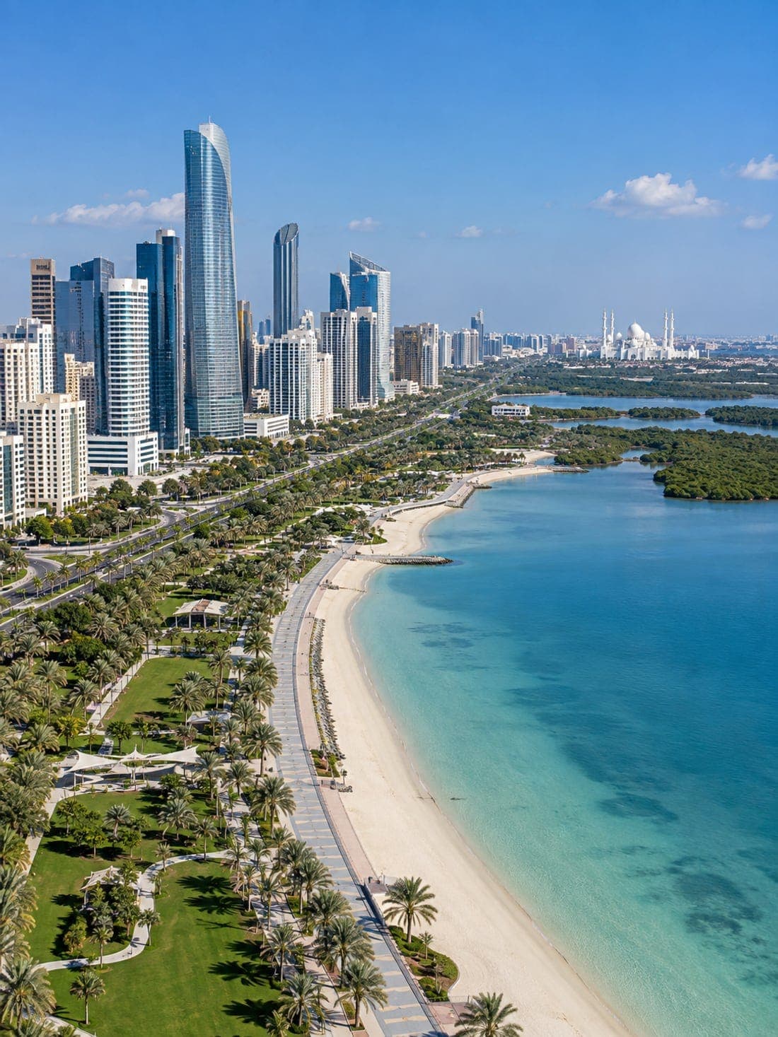 The Abu Dhabi corniche: a palm-lined promenade and beach beside turquoise water, with towers and mangroves beyond